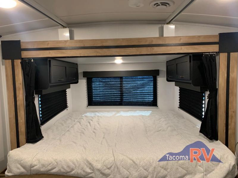 Cozy bedroom inside the Keystone Outback Ultra Lite Travel Trailer
